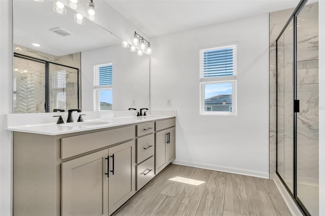 1003 Sugarwood St, Davenport, FL 33837 - full bath featuring double vanity, visible vents, a stall shower, and a sink