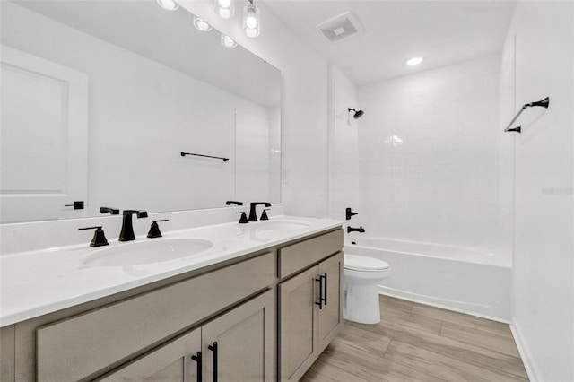 1003 Sugarwood St, Davenport, FL 33837 - bathroom with double vanity, visible vents, toilet, and a sink