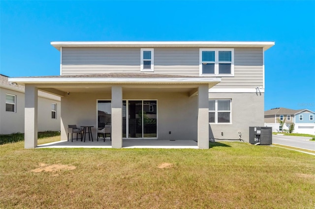 1003 Sugarwood St, Davenport, FL 33837 - rear view of property with a patio area, a lawn, and central AC