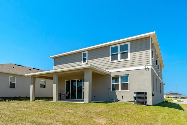 1003 Sugarwood St, Davenport, FL 33837 - back of property with a yard, central air condition unit, and stucco siding