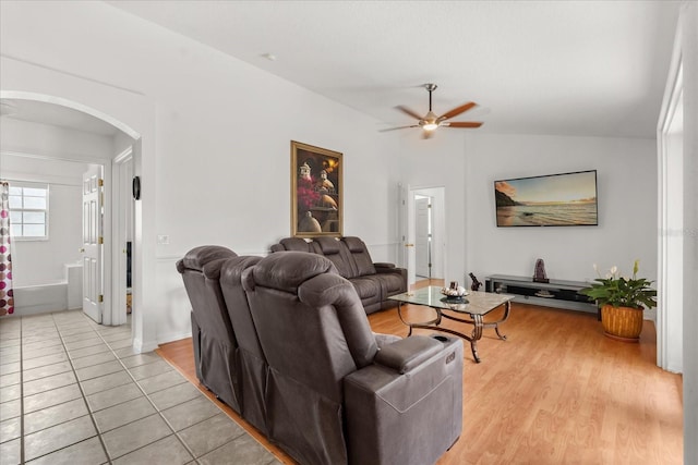 2289 Jessica Ln, Kissimmee, FL 34744 - living room featuring arched walkways, a ceiling fan, and light tile patterned floors