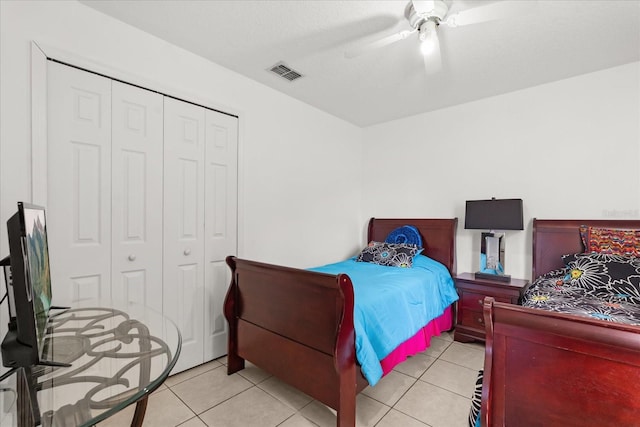 2289 Jessica Ln, Kissimmee, FL 34744 - tiled bedroom with a ceiling fan, visible vents, and a closet