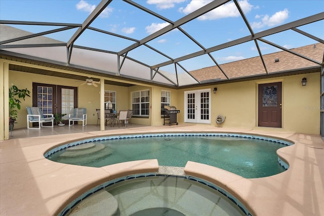 2289 Jessica Ln, Kissimmee, FL 34744 - view of swimming pool with a patio area, outdoor dining space, a ceiling fan, french doors, and a pool with connected hot tub