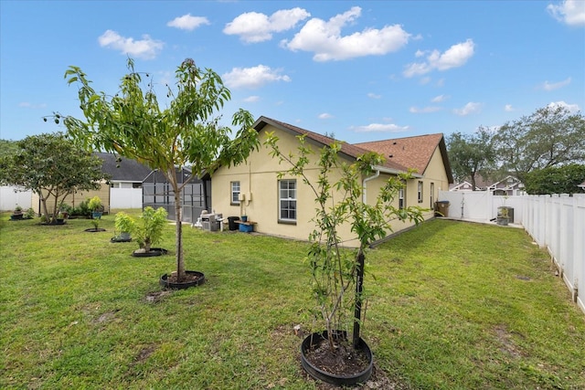 2289 Jessica Ln, Kissimmee, FL 34744 - view of home's exterior featuring a fenced backyard, a yard, and stucco siding