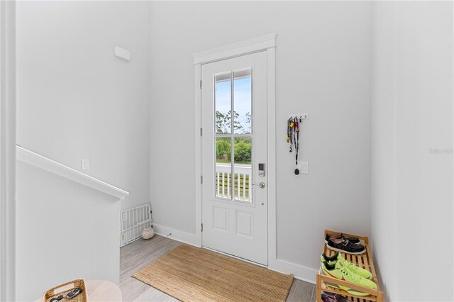 entryway with wood finished floors and baseboards