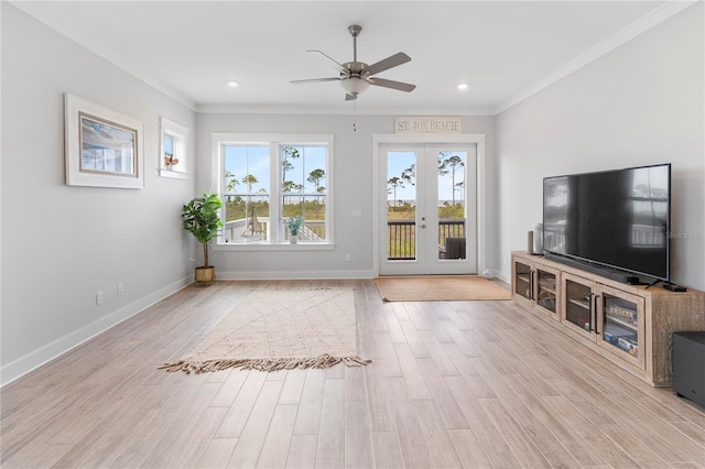 unfurnished living room featuring a ceiling fan, french doors, crown molding, wood finished floors, and baseboards