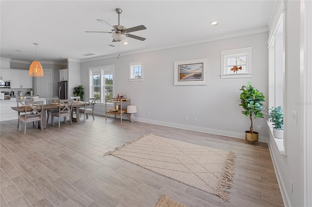 dining space with a ceiling fan, ornamental molding, light wood-style floors, recessed lighting, and baseboards