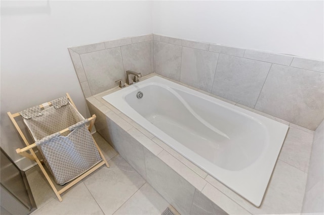bathroom with a bath and tile patterned floors