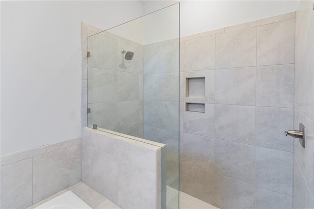 bathroom with walk in shower and a bath