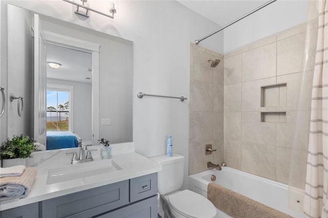 full bath with shower / tub combo with curtain, vanity, toilet, and ensuite bathroom