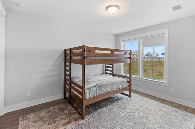 bedroom featuring baseboards and wood finished floors