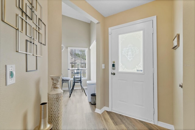 entrance foyer featuring baseboards and light wood finished floors