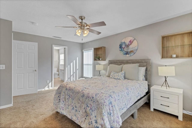 bedroom with a ceiling fan, carpet floors, baseboards, ensuite bath, and visible vents