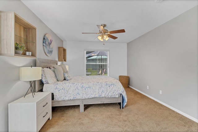 bedroom with ceiling fan, baseboards, and light colored carpet
