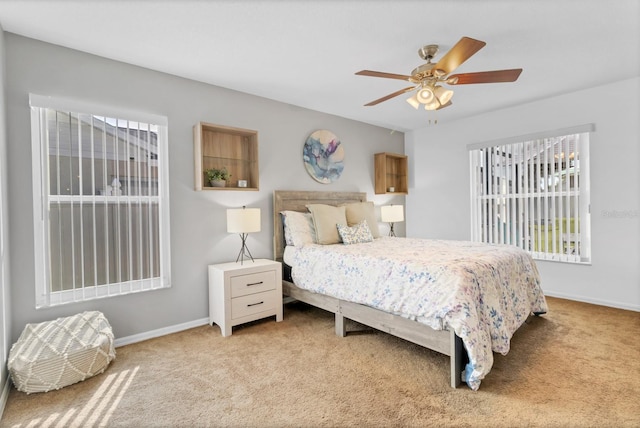 carpeted bedroom featuring baseboards and ceiling fan