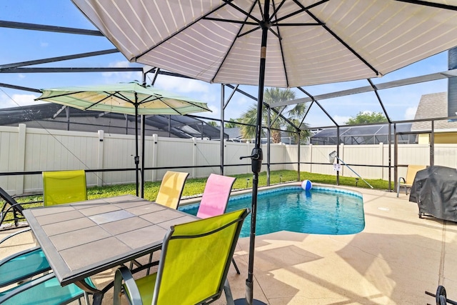 view of pool with glass enclosure, a patio area, a fenced in pool, and a fenced backyard