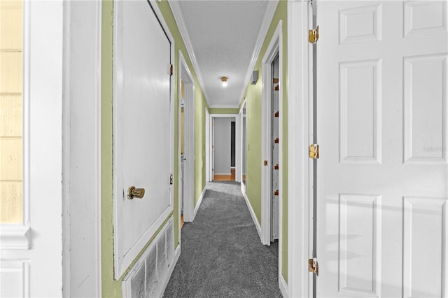 2430 Mill Run Blvd, Kissimmee, FL 34744 - hallway with dark carpet, baseboards, crown molding, and a textured ceiling