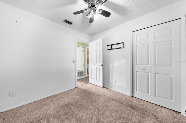 2430 Mill Run Blvd, Kissimmee, FL 34744 - unfurnished bedroom featuring carpet, a closet, a textured ceiling, baseboards, and ceiling fan