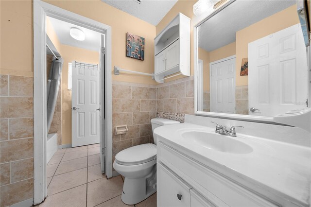 2430 Mill Run Blvd, Kissimmee, FL 34744 - full bath featuring tile walls, vanity, tile patterned flooring, toilet, and wainscoting