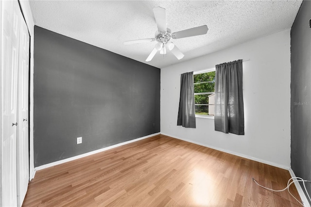 2430 Mill Run Blvd, Kissimmee, FL 34744 - empty room featuring wood finished floors, a textured ceiling, baseboards, and ceiling fan