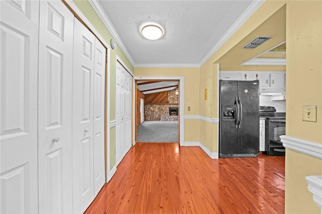 2430 Mill Run Blvd, Kissimmee, FL 34744 - hallway with a textured ceiling, light wood-type flooring, crown molding, and baseboards