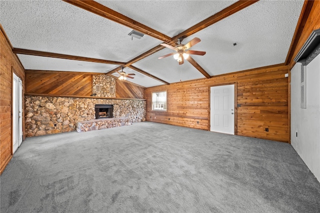 2430 Mill Run Blvd, Kissimmee, FL 34744 - unfurnished living room with ceiling fan, wooden walls, a textured ceiling, carpet, and a fireplace