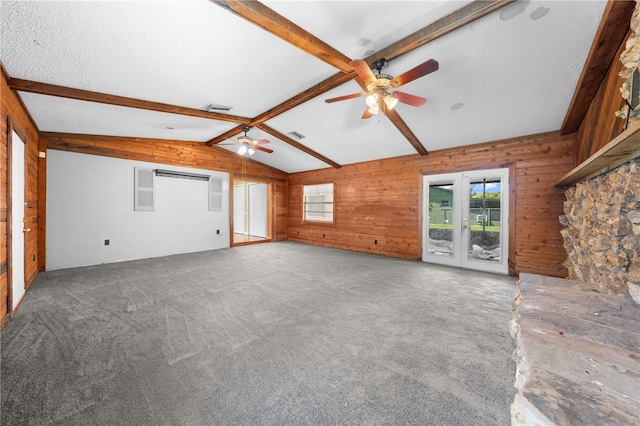 2430 Mill Run Blvd, Kissimmee, FL 34744 - unfurnished living room featuring a ceiling fan, carpet flooring, wood walls, and french doors