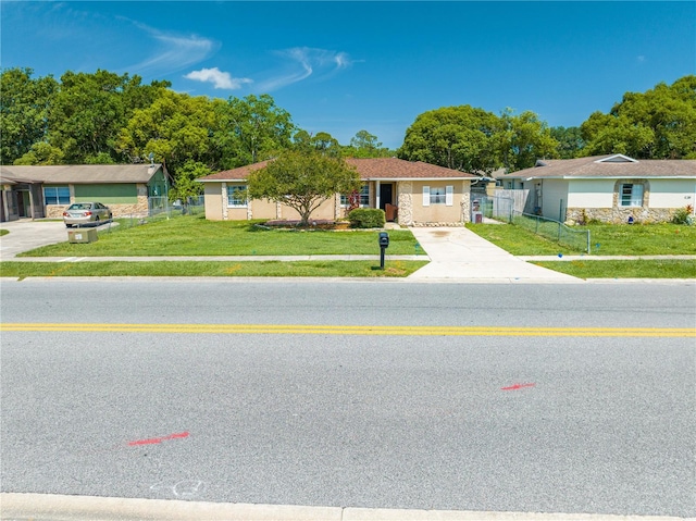 2430 Mill Run Blvd, Kissimmee, FL 34744 - ranch-style house with concrete driveway and view of scattered trees