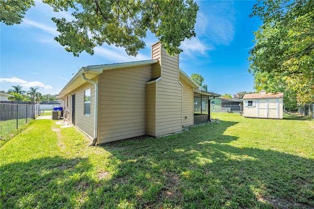 2430 Mill Run Blvd, Kissimmee, FL 34744 - back of house with a chimney and central AC unit