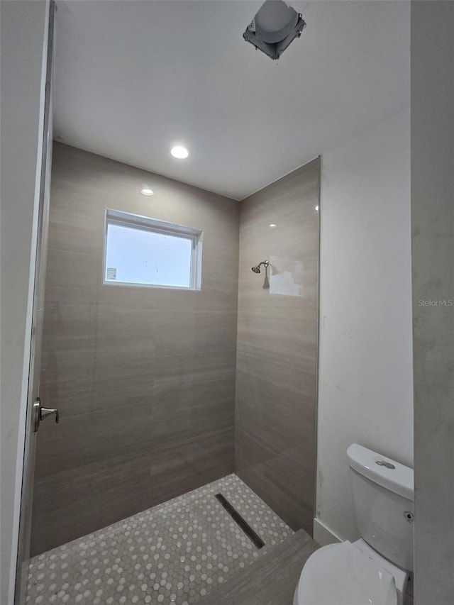 4098 New Milford St, North Port, FL 34288 - bathroom featuring a tile shower and toilet