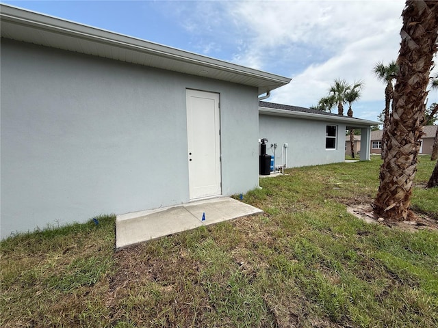 4098 New Milford St, North Port, FL 34288 - back of property with stucco siding and a yard
