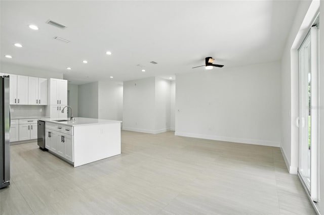 4098 New Milford St, North Port, FL 34288 - kitchen with appliances with stainless steel finishes, recessed lighting, open floor plan, white cabinets, and light countertops