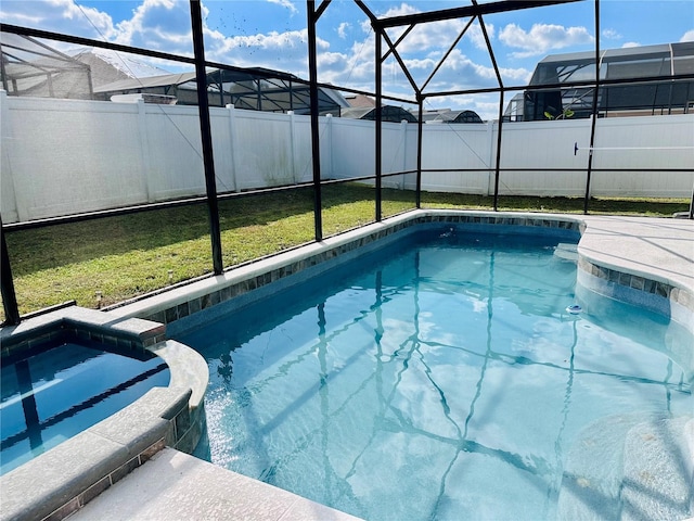 view of pool with a fenced backyard, a lanai, a pool with connected hot tub, and a lawn