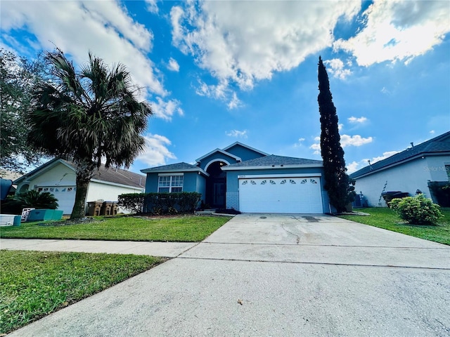 ranch-style home with a garage, a front yard, and concrete driveway