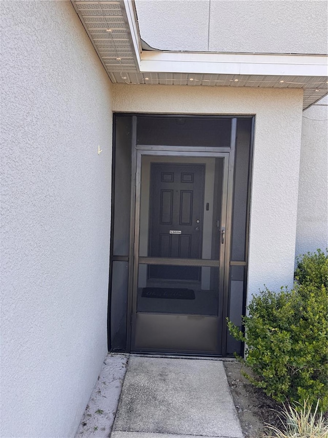doorway to property with stucco siding