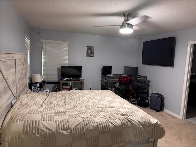 bedroom featuring a textured ceiling, a ceiling fan, and carpet floors