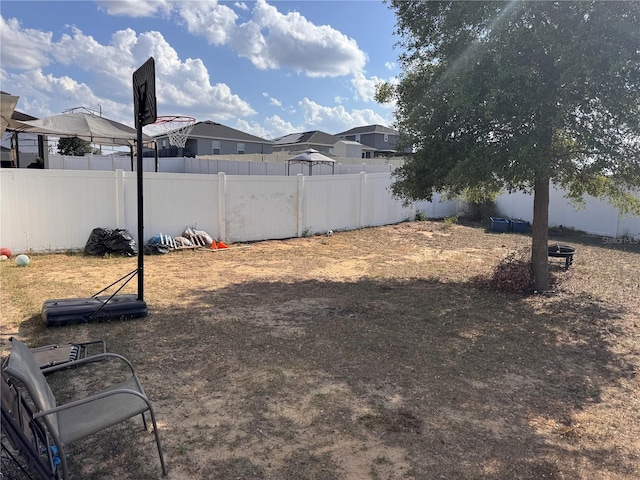 view of yard featuring a residential view and fence