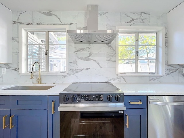 905 W 11th Ave, Mount Dora, FL 32757 - kitchen with island exhaust hood, range with electric cooktop, stainless steel dishwasher, blue cabinets, and a sink