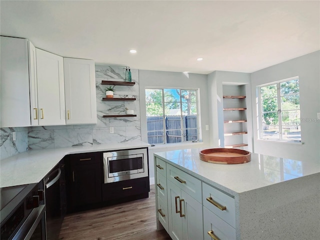 905 W 11th Ave, Mount Dora, FL 32757 - kitchen with open shelves, stainless steel microwave, healthy amount of natural light, white cabinets, and recessed lighting