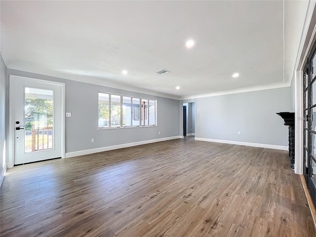 905 W 11th Ave, Mount Dora, FL 32757 - unfurnished living room with plenty of natural light, wood finished floors, baseboards, ornamental molding, and recessed lighting