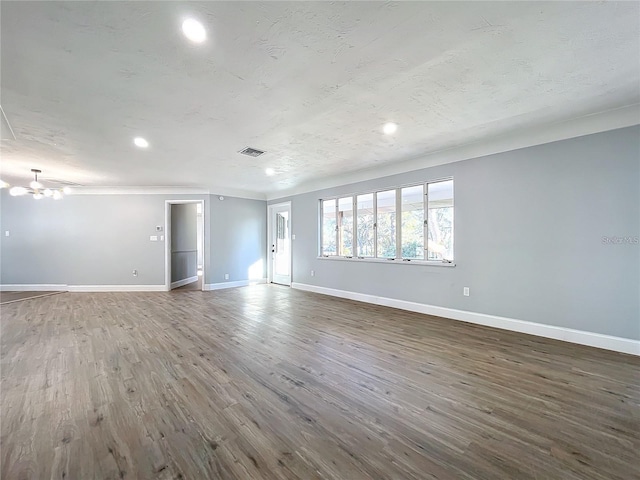 905 W 11th Ave, Mount Dora, FL 32757 - unfurnished living room with a chandelier, baseboards, wood finished floors, and recessed lighting