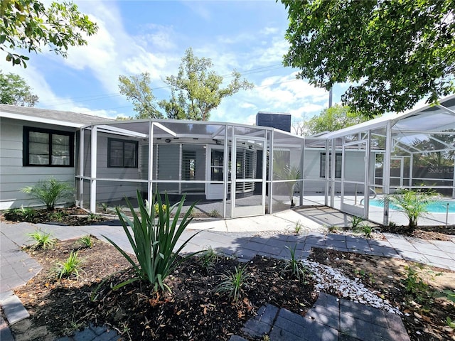 905 W 11th Ave, Mount Dora, FL 32757 - back of property featuring a lanai, a patio area, and an outdoor pool