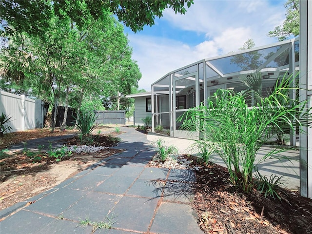 905 W 11th Ave, Mount Dora, FL 32757 - view of side of property featuring fence, a patio area, and glass enclosure
