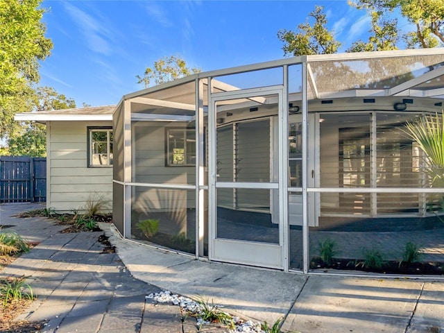 905 W 11th Ave, Mount Dora, FL 32757 - view of side of property with fence and a sunroom