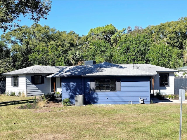 905 W 11th Ave, Mount Dora, FL 32757 - view of front of house with a front yard, a chimney, and a shingled roof