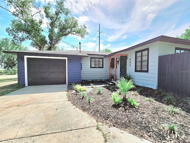 905 W 11th Ave, Mount Dora, FL 32757 - ranch-style home with a garage, concrete driveway, and fence