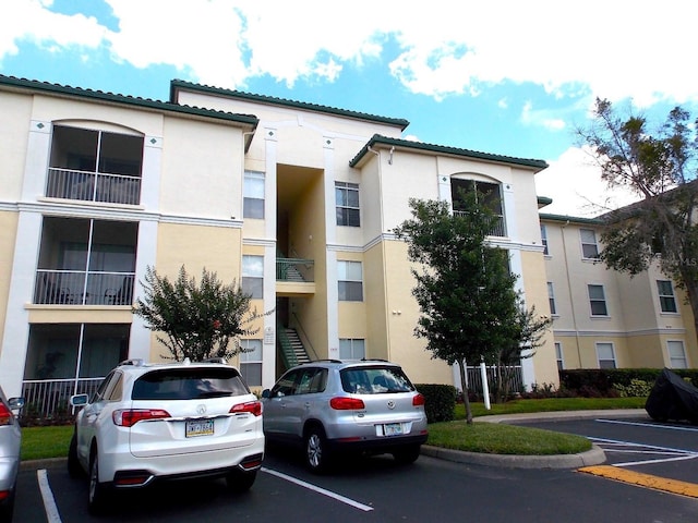 8809 Dunes Ct Unit 201, Kissimmee, FL 34747 - view of apartment building / complex featuring uncovered parking