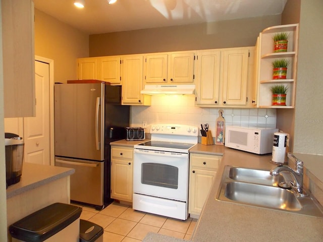 8809 Dunes Ct Unit 201, Kissimmee, FL 34747 - kitchen featuring white appliances, a sink, under cabinet range hood, light tile patterned flooring, and backsplash