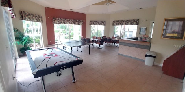 8809 Dunes Ct Unit 201, Kissimmee, FL 34747 - rec room featuring plenty of natural light, a ceiling fan, baseboards, and a raised ceiling