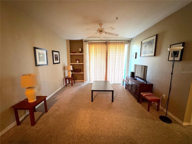 8809 Dunes Ct Unit 201, Kissimmee, FL 34747 - carpeted living area with baseboards, ceiling fan, and built in features